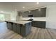 Large center island in kitchen with gray cabinets, modern appliances, and wood flooring at 476 Traditions Grande Blvd # 33, Wake Forest, NC 27587