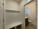 Bright mudroom features coat hooks, a bench, and convenient access to a half bathroom at 476 Traditions Grande Blvd # 33, Wake Forest, NC 27587