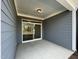 Covered back patio with sliding glass door access to backyard at 476 Traditions Grande Blvd # 33, Wake Forest, NC 27587