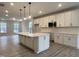 Modern kitchen with white cabinets and a large island at 486 Traditions Grande Blvd # 28, Wake Forest, NC 27587