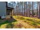 View of backyard featuring a small porch, a door to access home, and lush grass at 109 Lone Star Dr, Louisburg, NC 27549