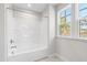 Bathroom featuring natural light and a bathtub with a shower head at 109 Lone Star Dr, Louisburg, NC 27549