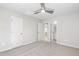 Bedroom featuring carpet, a ceiling fan, and two doorways for closet and bathroom access at 109 Lone Star Dr, Louisburg, NC 27549