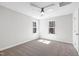 A spacious bedroom with carpet, a ceiling fan, and two windows providing natural light at 109 Lone Star Dr, Louisburg, NC 27549