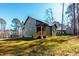 Exterior view of a green home with a backyard porch and lush green grass under a clear blue sky at 109 Lone Star Dr, Louisburg, NC 27549