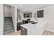 Bright kitchen with gray cabinets, white countertops, stainless appliances and convenient stair access at 109 Lone Star Dr, Louisburg, NC 27549