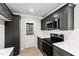 Contemporary kitchen boasts sleek gray cabinetry, subway tile backsplash, and access to the outdoors at 109 Lone Star Dr, Louisburg, NC 27549