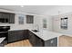 Open-concept kitchen with bar seating, quartz countertops, gray cabinets and stainless steel appliances at 109 Lone Star Dr, Louisburg, NC 27549