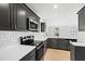 Modern kitchen features stainless steel appliances, gray cabinets, and white quartz countertops at 109 Lone Star Dr, Louisburg, NC 27549