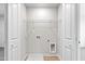 Functional laundry area with hookups, shelf, and double doors for clean, convenient clothes care at 109 Lone Star Dr, Louisburg, NC 27549