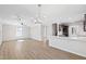 Spacious open-concept living and kitchen area with modern lighting and hardwood floors at 109 Lone Star Dr, Louisburg, NC 27549