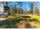 View of the large backyard and a glimpse of the house exterior at 169 Running Deer Dr, Louisburg, NC 27549