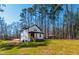 A modern two story home is surrounded by towering pine trees and a grassy lawn at 169 Running Deer Dr, Louisburg, NC 27549