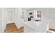 Well-lit kitchen with white cabinets, stainless appliances, and hardwood floors at 169 Running Deer Dr, Louisburg, NC 27549
