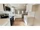 Modern kitchen featuring white cabinets, quartz countertops, and stainless steel appliances at 169 Running Deer Dr, Louisburg, NC 27549