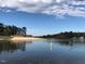 Community lakefront view with sandy beach and clubhouse at 169 Running Deer Dr, Louisburg, NC 27549