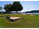 Lakefront recreation area featuring a sandy beach, swimming area, and scenic water views for outdoor enjoyment at 169 Running Deer Dr, Louisburg, NC 27549