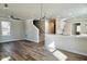 Spacious living room with hardwood floors, a ceiling fan, and a modern chandelier at 169 Running Deer Dr, Louisburg, NC 27549