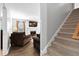 Staircase and living room with a fireplace and large tv at 170 Carrington Ave, Franklinton, NC 27525