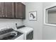 Convenient laundry room with washer, dryer, and overhead cabinets at 2301 Beeblossom Pl, Fuquay Varina, NC 27526