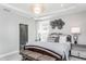 Main bedroom with king bed and ensuite bathroom, featuring decorative wall art at 2301 Beeblossom Pl, Fuquay Varina, NC 27526