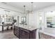 Open concept kitchen with large island and view into adjacent living area at 2513 Shorebird Dr, Fuquay Varina, NC 27526