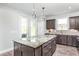 Kitchen island with granite countertop and stainless steel appliances at 2513 Shorebird Dr, Fuquay Varina, NC 27526
