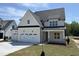 Beautiful two-story home featuring a three-car garage and a welcoming front porch at 3520 Amelia Grace Dr # 30, Fuquay Varina, NC 27526