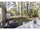 View of the backyard with mature trees, a white fence and A/C unit at 3540 Chelsea Dr, Rocky Mount, NC 27803