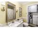 Bright bathroom with a large mirror, single sink vanity, and laundry through an adjacent door at 3540 Chelsea Dr, Rocky Mount, NC 27803