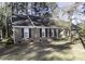 Traditional brick home with black shutters, complemented by natural surroundings and mature trees at 3540 Chelsea Dr, Rocky Mount, NC 27803