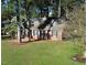 Charming brick home featuring manicured lawn and mature trees, offering a tranquil and inviting setting at 3540 Chelsea Dr, Rocky Mount, NC 27803