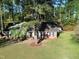 Aerial view of a brick home with a lush lawn and mature trees, and a driveway on the side at 3540 Chelsea Dr, Rocky Mount, NC 27803