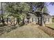 Charming front facade featuring mature trees with a well maintained lawn at 3540 Chelsea Dr, Rocky Mount, NC 27803