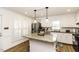 Bright kitchen featuring granite countertops, white cabinetry, stainless steel appliances, and a central island with pendant lighting at 3540 Chelsea Dr, Rocky Mount, NC 27803
