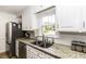 Kitchen featuring granite countertops, a stainless steel refrigerator, and a garden window above the sink at 3540 Chelsea Dr, Rocky Mount, NC 27803