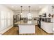 Open kitchen offers stainless appliances, granite countertops, white cabinets and island seating at 3540 Chelsea Dr, Rocky Mount, NC 27803