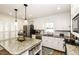 This open kitchen offers a spacious island with granite countertops and white cabinets at 3540 Chelsea Dr, Rocky Mount, NC 27803