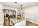 Kitchen island with granite countertops, pendant lighting, and white cabinetry with a view to the living room at 3540 Chelsea Dr, Rocky Mount, NC 27803