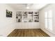 Room featuring beautiful hardwood flooring, large built-in shelving with decorative accents, and natural light from the window at 3540 Chelsea Dr, Rocky Mount, NC 27803