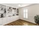 Room featuring beautiful hardwood flooring, large built-in shelving with decorative accents, and natural light from the window at 3540 Chelsea Dr, Rocky Mount, NC 27803