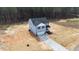 Aerial view of a two-story home with light blue siding, garage and porch at 9133 Phoenix Ct, Middlesex, NC 27557