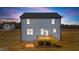 Two-story home exterior with a wooden deck and light blue siding at dusk at 9133 Phoenix Ct, Middlesex, NC 27557