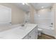 Bathroom with white vanity, quartz countertop and tub with white shower surround at 9133 Phoenix Ct, Middlesex, NC 27557