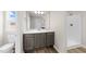 Bathroom featuring wood-look floors, single vanity with white countertop, and tiled walk-in shower at 9133 Phoenix Ct, Middlesex, NC 27557