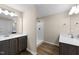 Bathroom features wood-look floors, dual vanity with white countertop, and tiled walk-in shower at 9133 Phoenix Ct, Middlesex, NC 27557