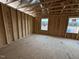 Unfinished bedroom with two windows and hardwood floors at 9133 Phoenix Ct, Spring Hope, NC 27882