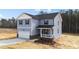 Two-story home with blue siding, an attached two-car garage, and a covered porch at 9133 Phoenix Ct, Middlesex, NC 27557