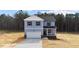 Two-story home with light blue siding, garage and porch at 9133 Phoenix Ct, Middlesex, NC 27557