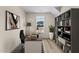 Functional home office with a spacious desk, built-in shelving, and a tranquil view, fostering productivity at 9133 Phoenix Ct, Middlesex, NC 27557